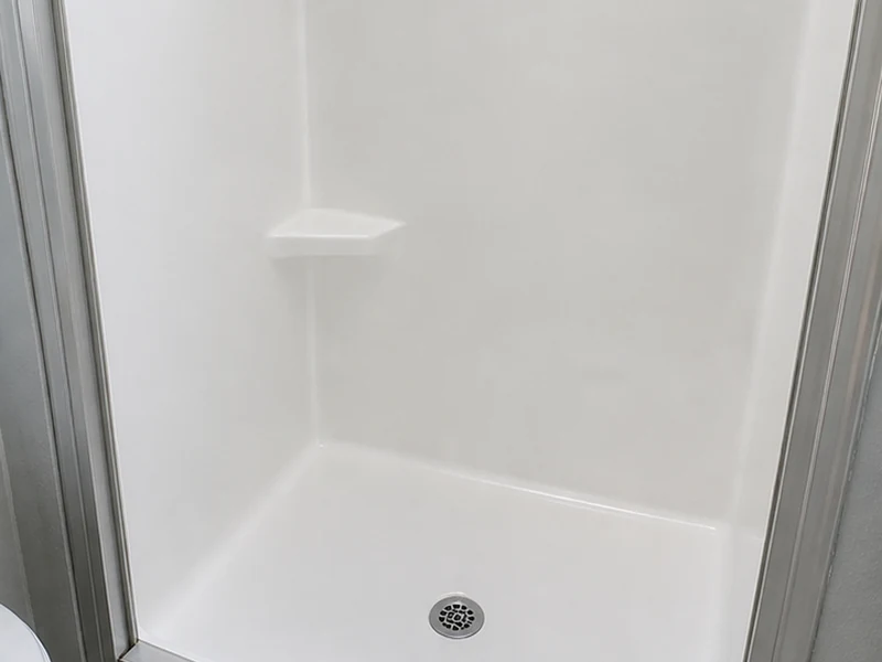 Same fiberglass shower stall refinished glossy white in a Cherryland apartment, Hayward